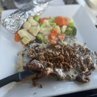 a plate of food with meat and vegetables