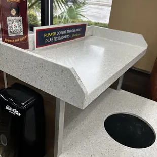 I like that you can throw away your trash without having to touch the lid of the trash can, plus there is hand sanitizer right next to it.