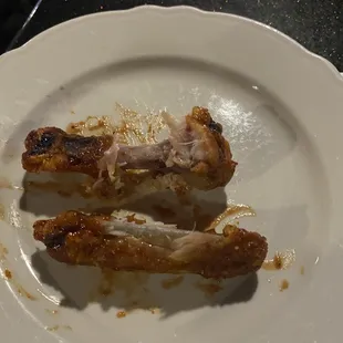 two pieces of chicken on a white plate