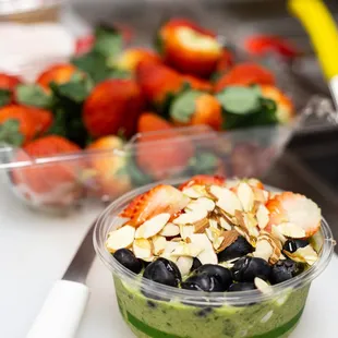 Super Green Bowl: Base - banana, spinach, kale, cucumber, apple, moringa, lemon, almond milk, toppings - blueberries, strawberries, almonds