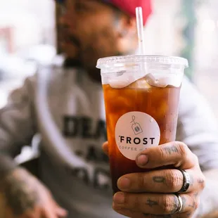 a man holding a drink