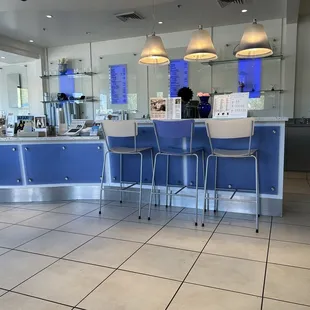 a counter and chairs in a restaurant