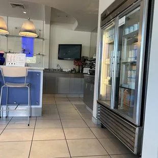 a kitchen with a refrigerator and a bar