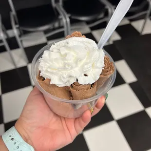  hand holding a cup of ice cream