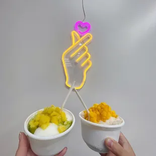 Yogurt bingsoo with green grape flavoring and pineapple and vanilla bingsoo with citron flavoring and mango.