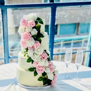 a wedding cake with pink and white flowers