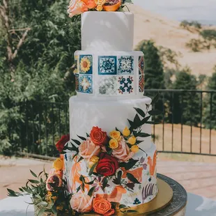 a three tiered cake decorated with colorful flowers