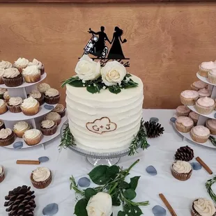 a wedding cake and cupcakes