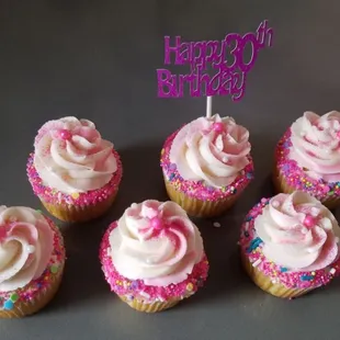 Yummy vanilla cupcakes pretty pink sprinkles and a custom topper.