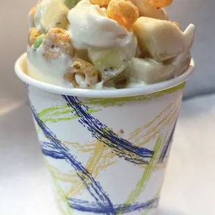 a paper cup filled with cereal and marshmallows