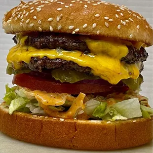 a hamburger with cheese and lettuce