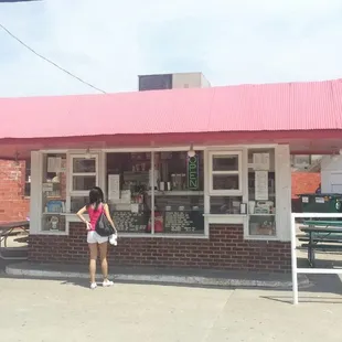 a woman standing in front of a store