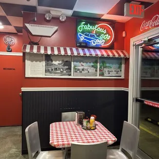 Wall art of past photos and most current of restaurant