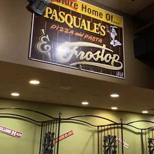 a restaurant with a sign above the tables