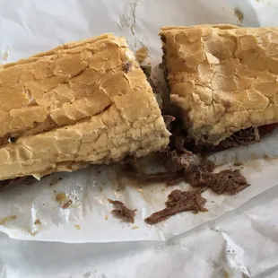 a sandwich cut in half on a piece of paper