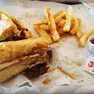 a sandwich and french fries with ketchup