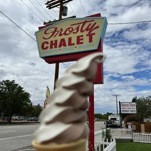 a hand holding an ice cream cone