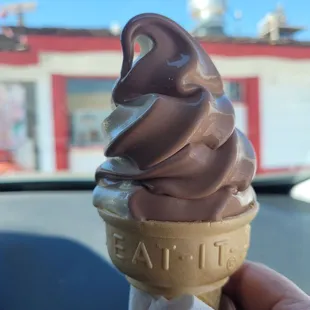 a person holding an ice cream cone