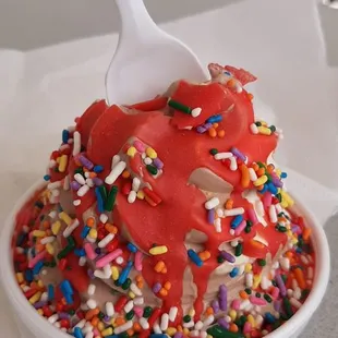 a bowl of sprinkles and a spoon