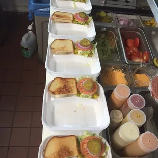 a long line of trays of sandwiches