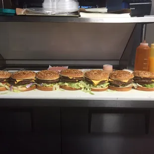 a row of hamburgers on a counter