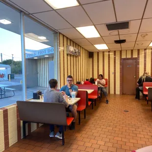 people sitting at tables in a restaurant