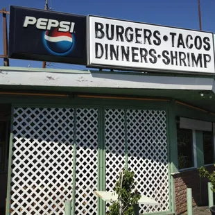 a restaurant with a sign that says burgers tacos diners shrimp
