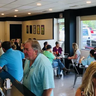 a large group of people sitting at tables in a restaurant