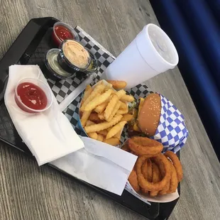 a tray of fries, onion rings and ketchup