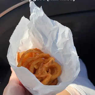 a person holding a bag of churros