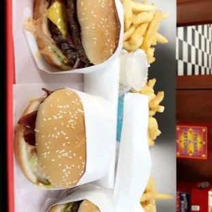 three hamburgers and french fries