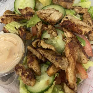 chicken, lettuce, tomato, cucumber, and dressing