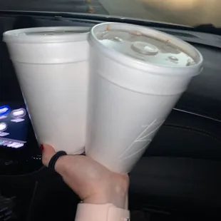 two cups of coffee in a car