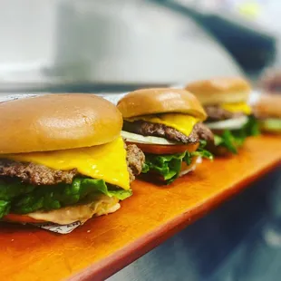 three hamburgers with cheese and lettuce
