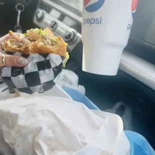 a hand holding a sandwich