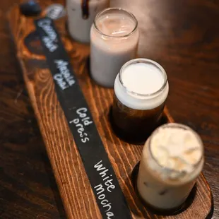 three drinks on a wooden tray