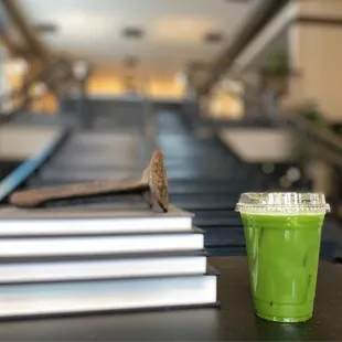 a glass of green juice on a table