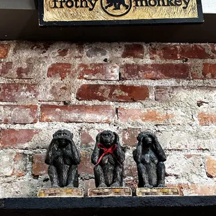 three monkeys on a shelf