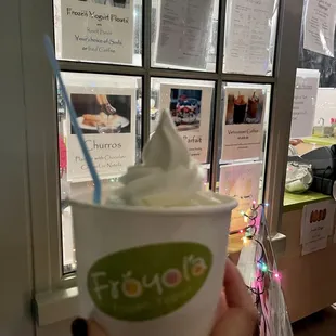 a person holding a cup of ice cream