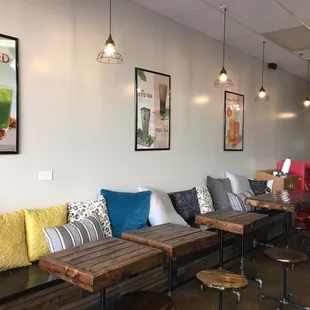 a row of benches with colorful pillows