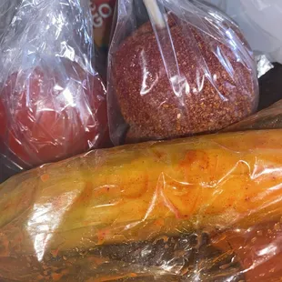 Cucumber with lime and chamoy in a bag / candy apples with Lucas