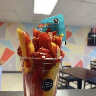 strawberries, bananas, and strawberries in a cup