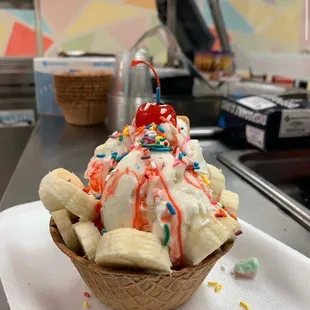 an ice cream sundae with sprinkles and a cherry on top