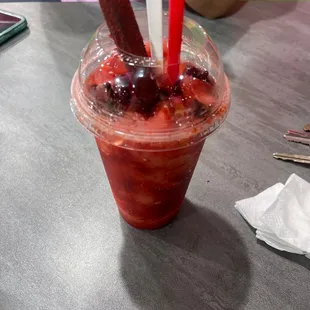 strawberries and strawberries in a plastic cup