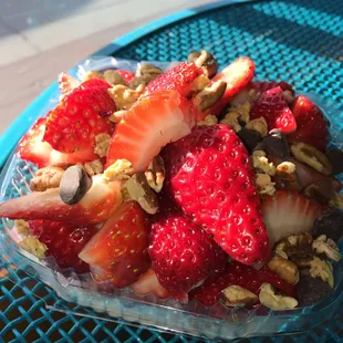 strawberries and nuts in a plastic container
