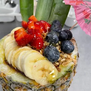 a pineapple topped with fruit