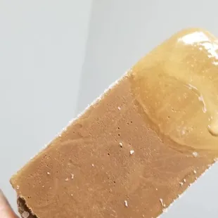 a hand holding a piece of ice cream