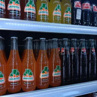 a shelf of sodas and soft drinks