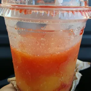 a person holding a drink in their hand