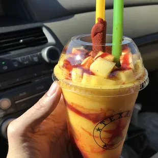 a person holding a drink in a car